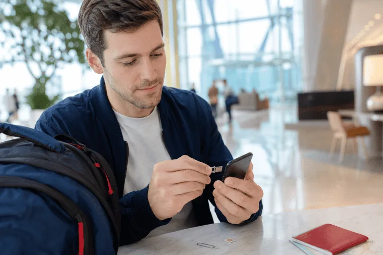 Traveler installing a SIM card to stay connected after arriving in China
