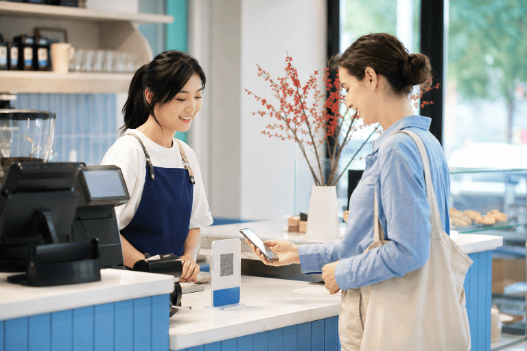 Visitor paying by smartphone at a café in China